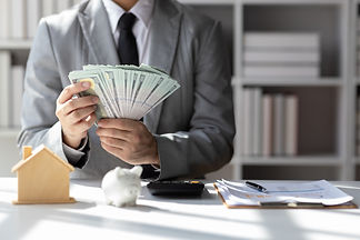 Businessman holding banknotes and counting money, savings, rent, cash flow, accounting, re