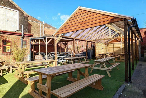 Timber beer garden structure at the artichoke pub norwich with PVC roof