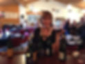 Melanie Webber at wine tasting with bottles of wine