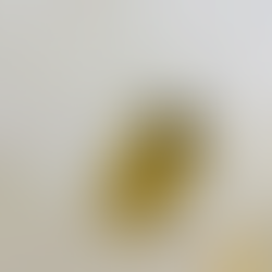 A close-up view showing neat hands holding a white bed sheet with a clean, tan snap-on label that clearly displays "King" and "Bottom Right" for easy size identification in a linen closet