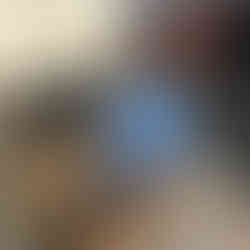 Cardboard box filled with old electronics, keyboard, and storage bins placed outside during a garage decluttering project, ready for electronic reaching