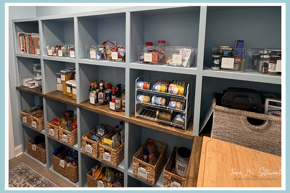 Organized pantry with labeled wicker baskets, canned goods, and spices on blue shelves. Wooden counter and rug visible. Calm and tidy mood.