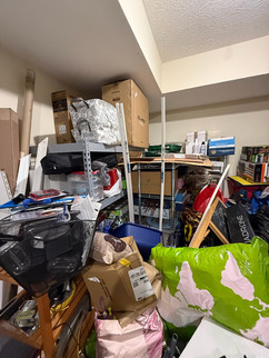 Overwhelmed garage space filled with stacked bins, bikes, tools, furniture, and miscellaneous clutter—capturing the before scene of a real-life garage makeover by Tara Stewart, professional organizer in Lexington, Kentucky.