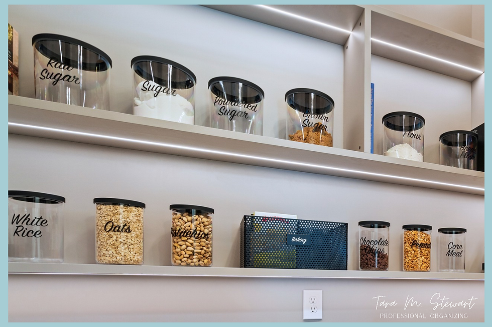 Multi-tiered LED backlit pantry shelves featuring decanted baking canisters with custom script labels and black mesh storage baskets organized by Tara M. Stewart Professional Organizing.