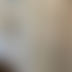 White kitchen cabinet doors in an Airbnb featuring gold handles and elegant gold lettering labels for dishes