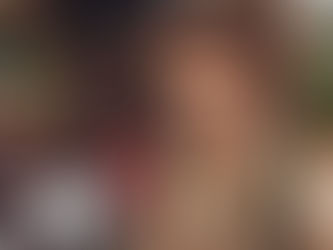 Smiling person in a hat with children in front of a thatched hut. Dental tools visible. Bright, warm setting conveying joy.