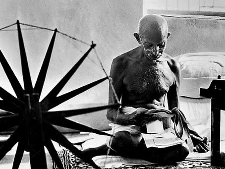 Ghandi operating a spinning wheel