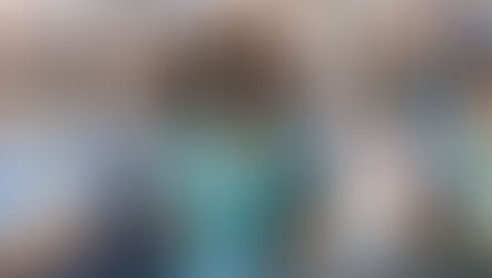 Medical staff in scrubs and masks hold newborns in a hospital. Two babies in bassinets in front. Bright, professional, caring mood.