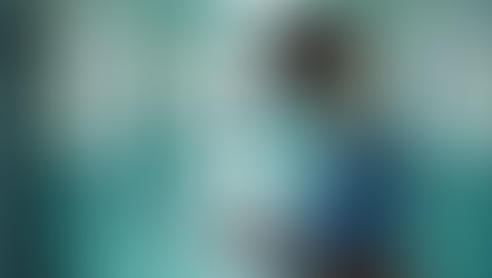 nurse taking notes on a clipboard in the hallway