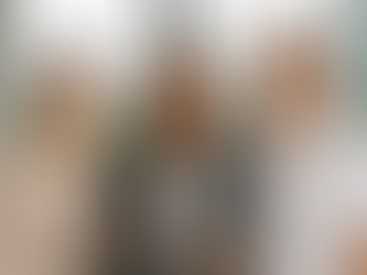 Young Asian woman professional with the traditional Asian parents in front of a window with a view of a large city in the distance