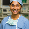 Indian woman CRNA in blue scrubs with mask