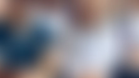 Medical students in uniforms sit attentively in a classroom setting, stethoscopes around necks, focused on a lecture. Bright, professional mood.