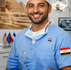 Middle Eastern Dentist in Blue Scubs with US and Egyptian Flags in background