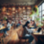 People studying on laptops in a cozy library cafe. Wooden shelves filled with books and plants create a warm atmosphere.