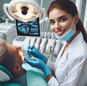 Dentist in white coat and mask examines a patient under a dental light. X-ray images display on a screen. Bright, modern clinic setting.