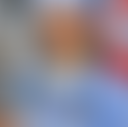 CRNA originally from the Caribbean smiling in blue scrubs