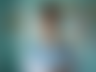 A nurse with stethoscope and blue scrubs pursuing higher education.