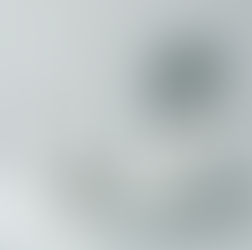 White dental tools and toothbrushes on a tray, with a small mirror and toothpaste. Minimalist setting with a clean, organized look.