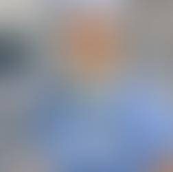 Chinese speaking CRNA smiling in blue scrubs with stethoscope