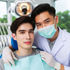 Dentist in a blue mask and scrubs examines a calm patient in a dental chair. Bright, clinical setting with soft lighting.