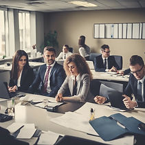 seven executives working in a room with long tables and office equipment