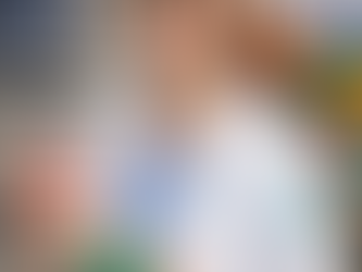 orthodontist in white lab coat holding dental model