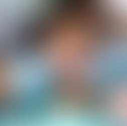 A dentist wearing gloves examines a patient's open mouth with dental tools. The setting is a dental office. The mood is clinical.