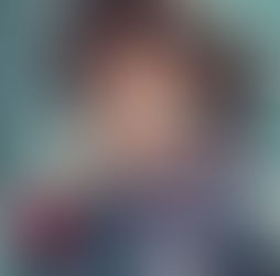 Smiling child in plaid pajamas brushes teeth in a bathroom. Reflection in mirror. Cheerful mood with a colorful toothbrush.