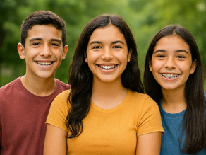 three Latino children showing off new braces on their teeth