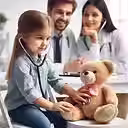 Girl in denim uses a stethoscope on a teddy bear. Two smiling doctors in white coats watch in a bright, clinical setting.