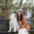 Professional mental health counselor in Toronto sitting with her white Samoyed dog, Fiona, practicing a moment of mindful self-care and quiet connection.