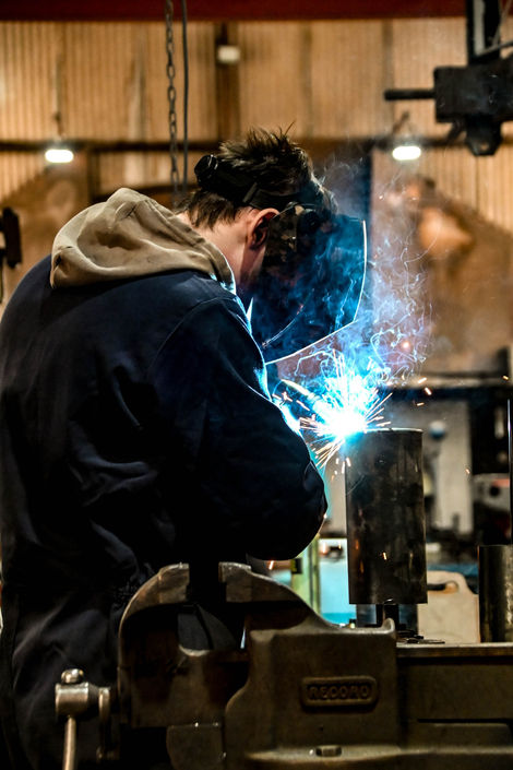 Welder working with sparks and metal