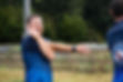 Man stretching arm before run. Rhayader Running Clu, training session outdoors.