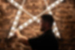 Man installing illuminated star wall decor