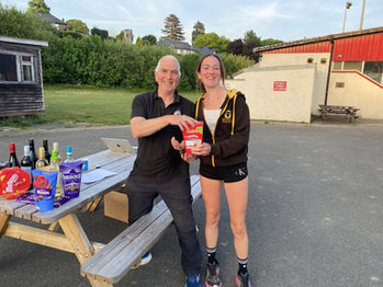 Man and woman pose with prizes after Rhayader Running Club event.