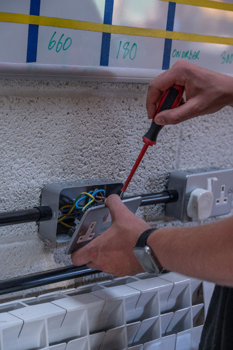 Electrician installing electrical outlet