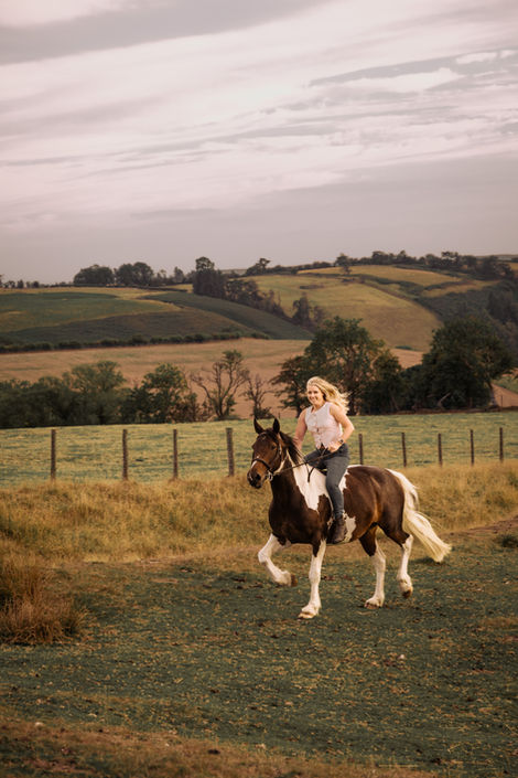 Girl horseback riding in scenic countryside
