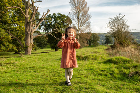 Happy girl in rusty dress, peace signs