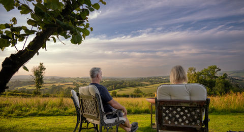 Couple enjoying sunset view from Cherry Tree Lodges