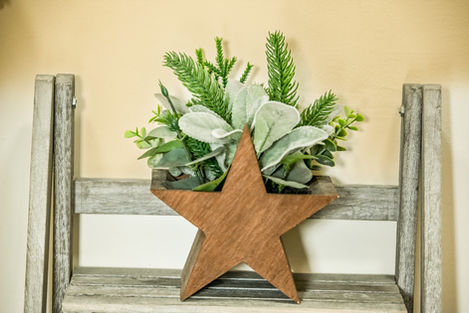 Rustic star-shaped planter with greenery