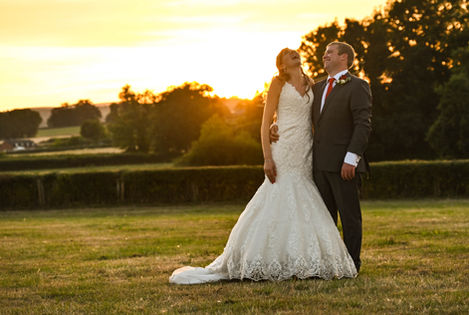 Happy wedding couple at sunset