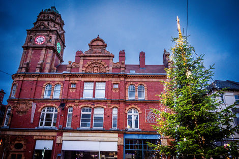 Christmas tree outside historic red brick building