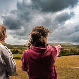 Two girls view scenic landscape