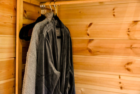 Soft robes hanging in Cherry Tree Lodges
