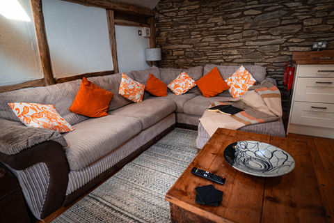 Cozy L-shaped sectional sofa with orange pillows
