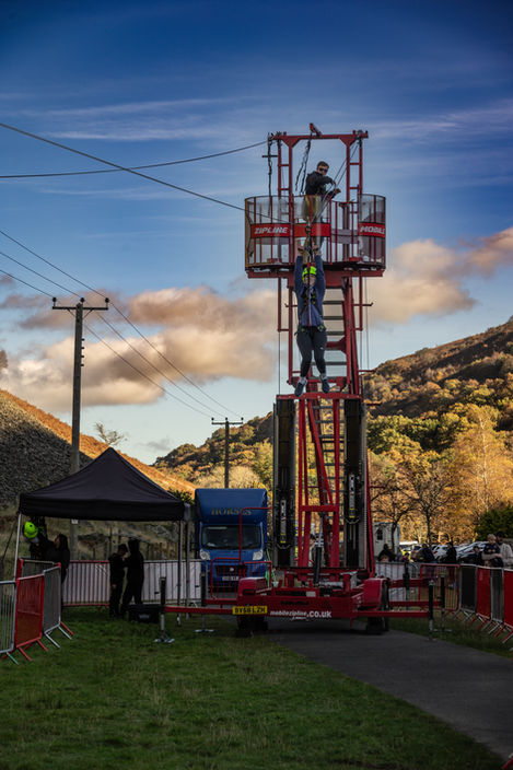 Man rappelling from tall tower, event