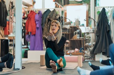 Serena in a yoga class demonstrating a pose Serenity Yoga
