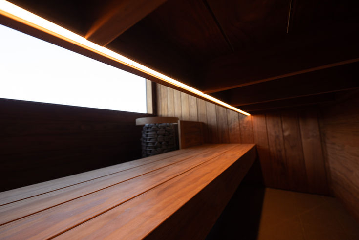 Warm lit wooden sauna bench