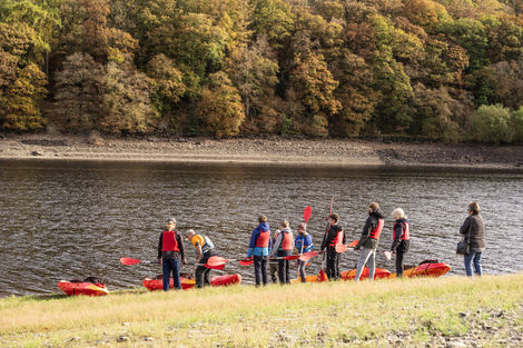 Kayakers preparing for autumn paddle