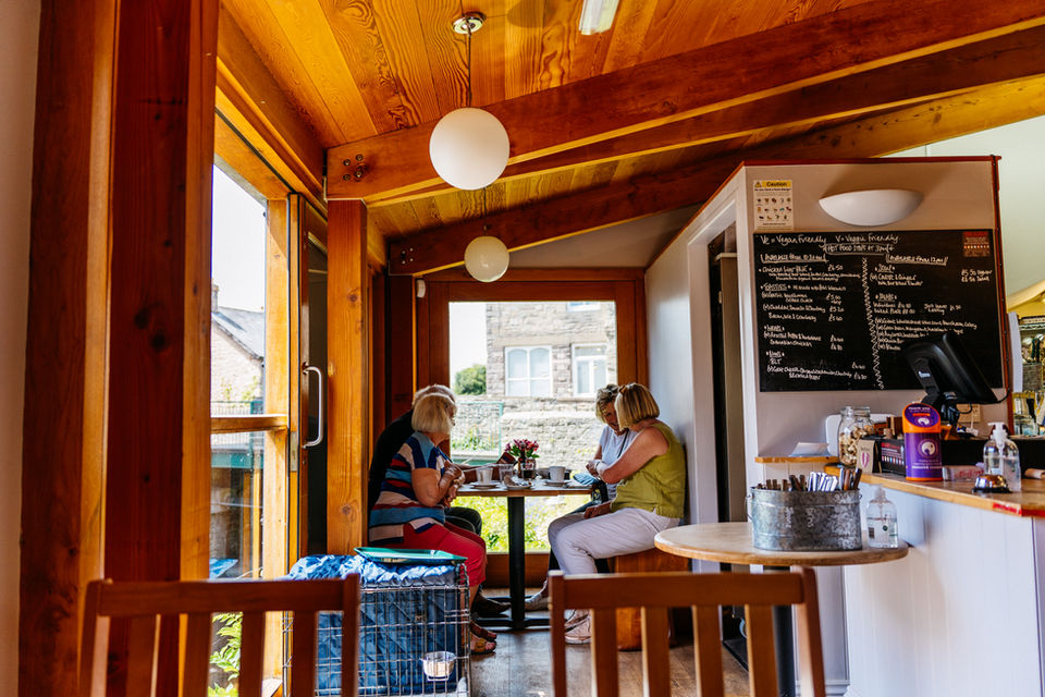 friends enjoying a cuppa together in a local cafe
